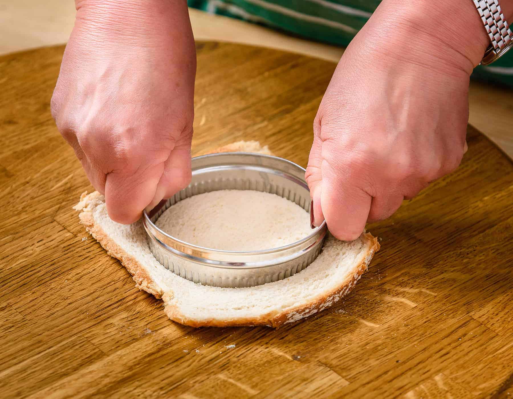 Cutting bread with a biscuit cutter.