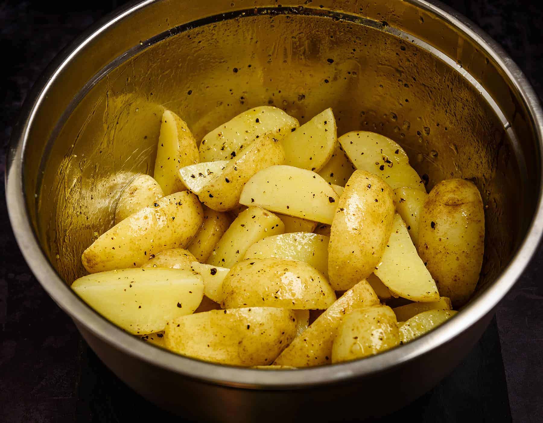 Potato wedges tossed in salt and pepper mixture