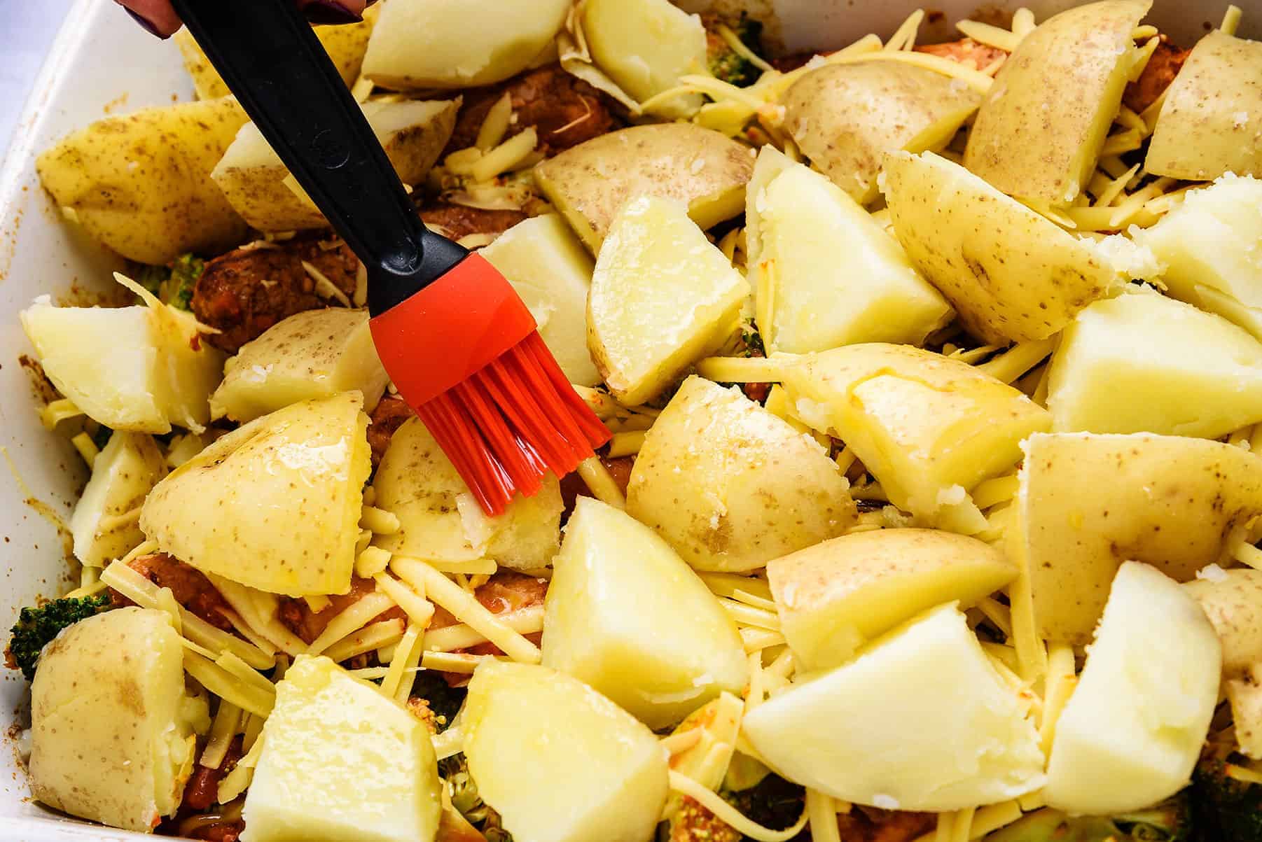 Brushing potatoes with melted vegan butter