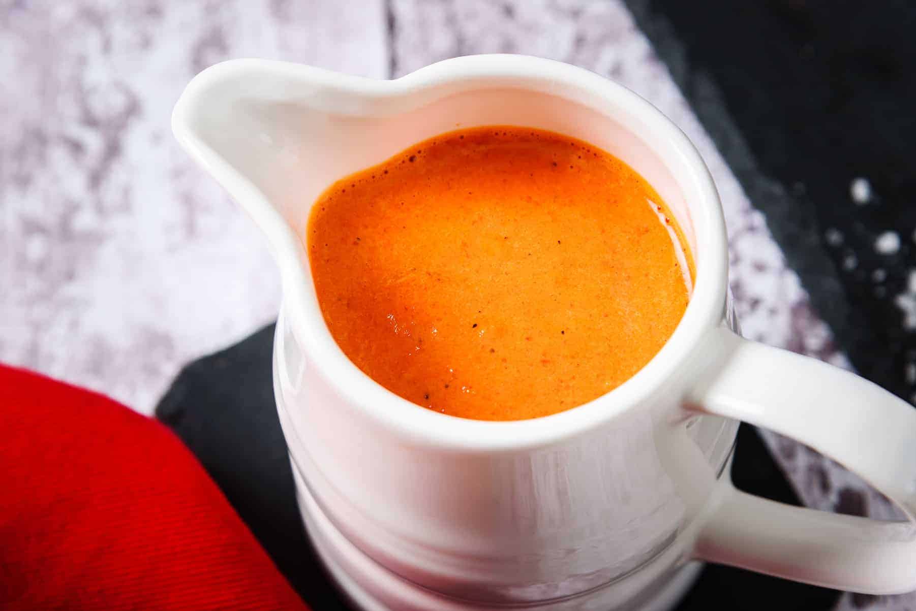 Close up of Vegan Roasted Red-Pepper Sauce in a Jug