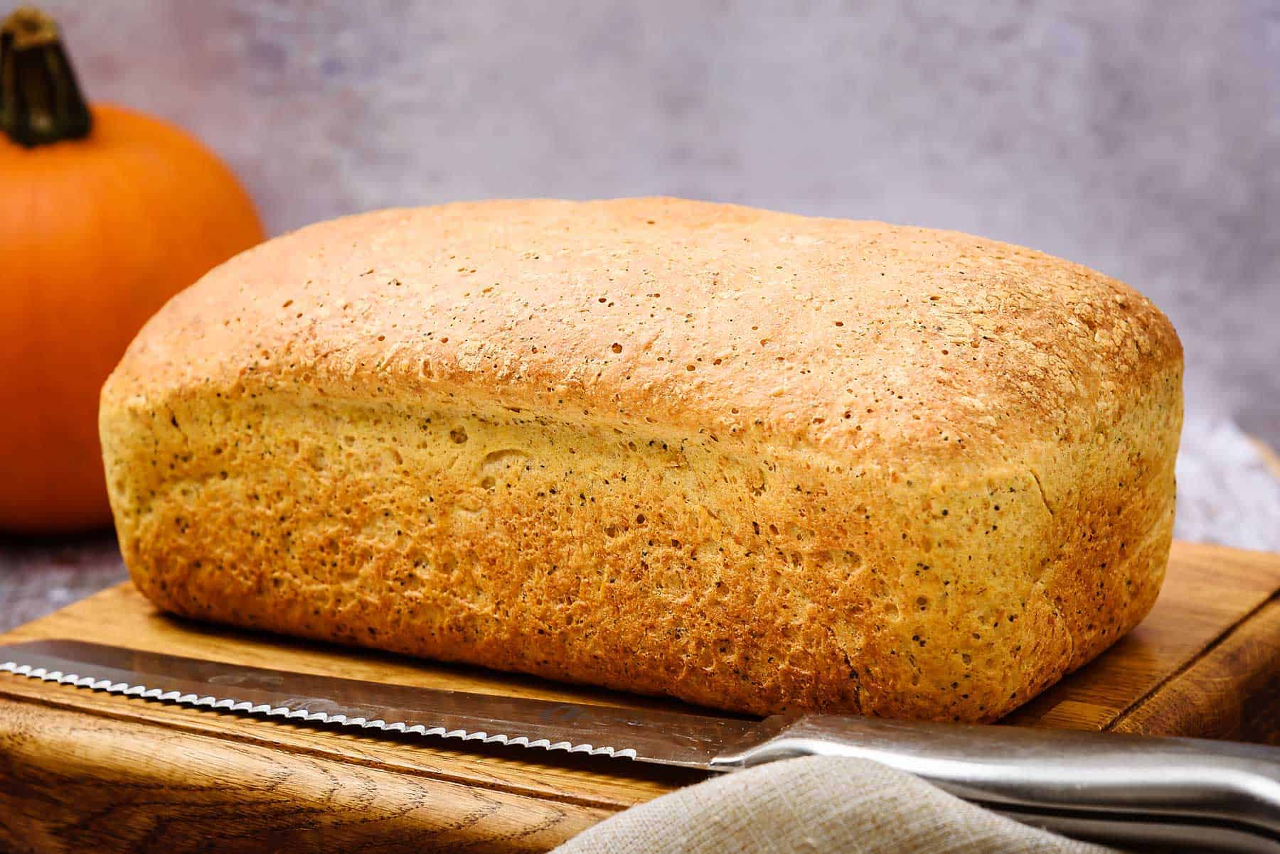A cooked loaf of Vegan 3-Seeded Pumpkin Bread