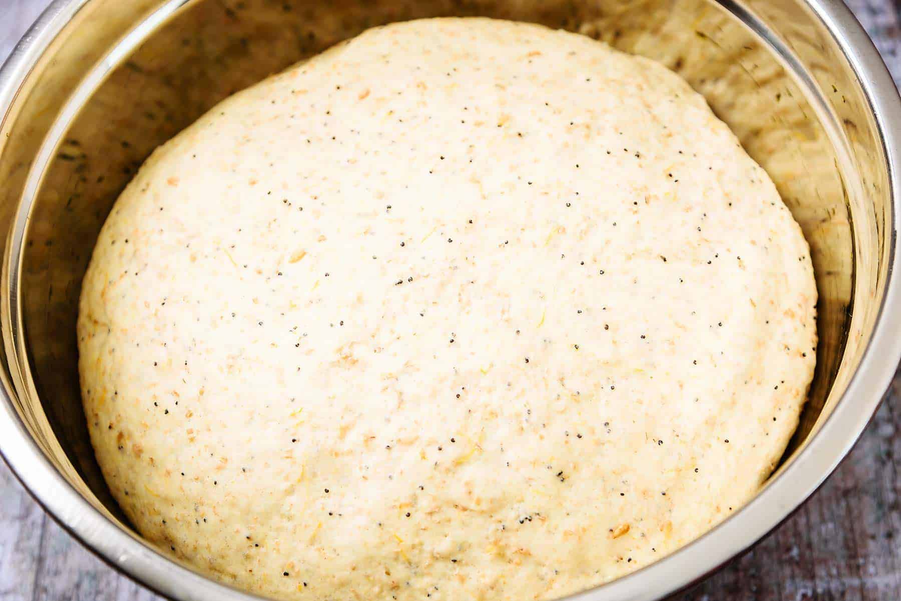 Dough doubled in size in a bowl after the first rise