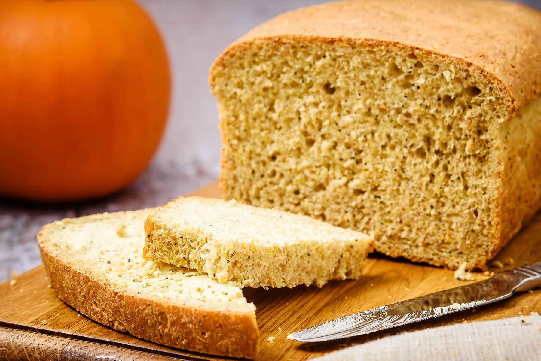 Slice of Vegan 3-Seeded Pumpkin Bread with a bite taken