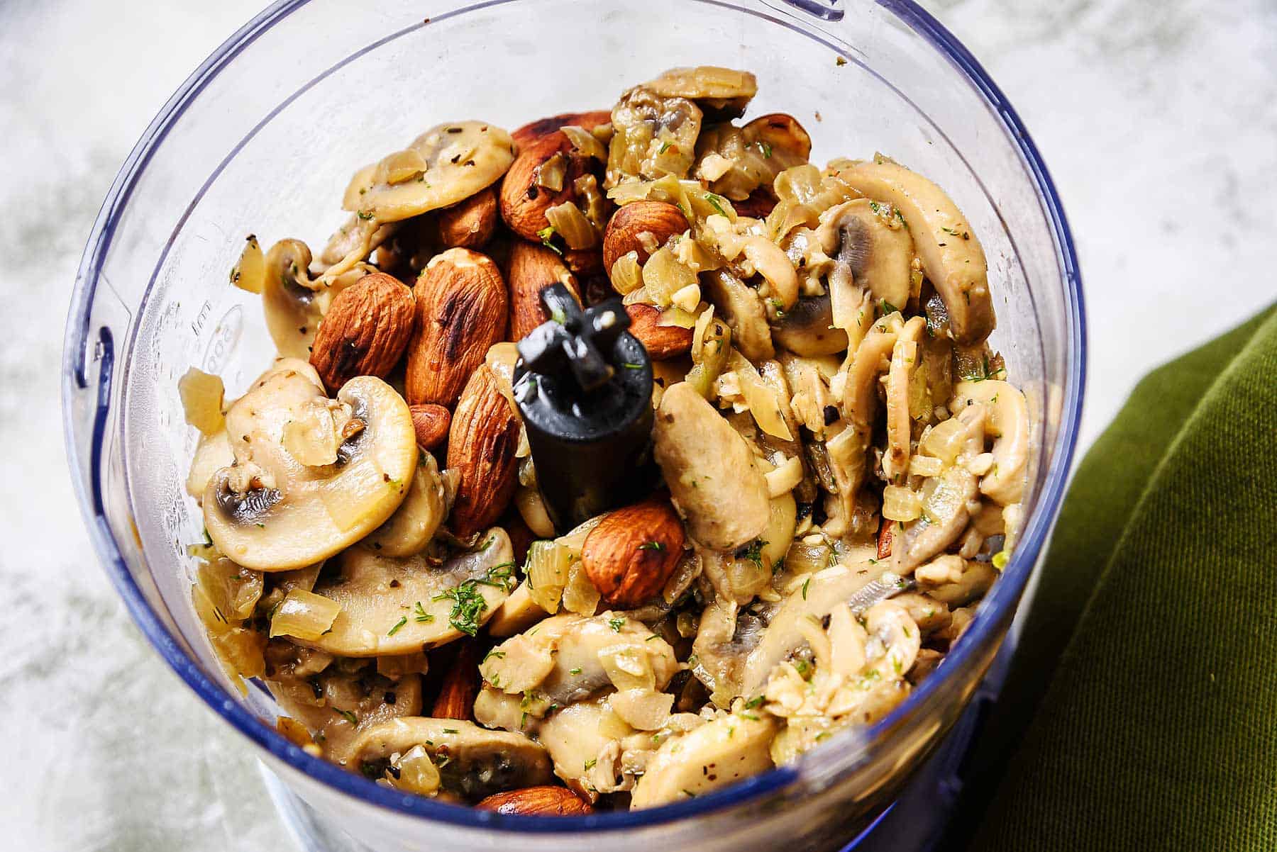 Cooked mushrooms and almonds in a blender
