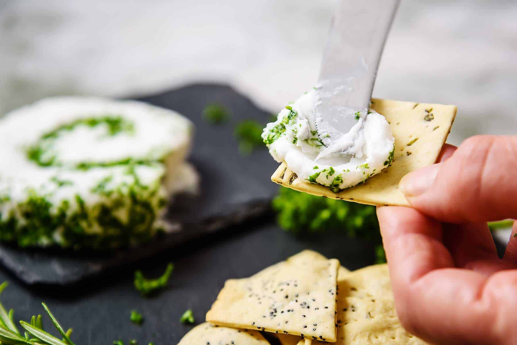 Spreading Vegan Le Roulé Cheese on a cracker