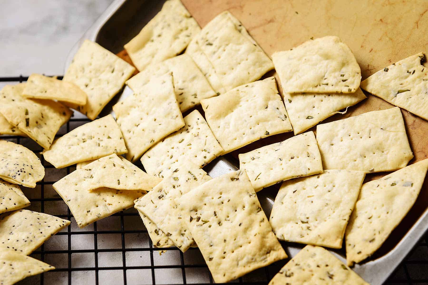 Tipping cooked crackers onto a wire rack to cool