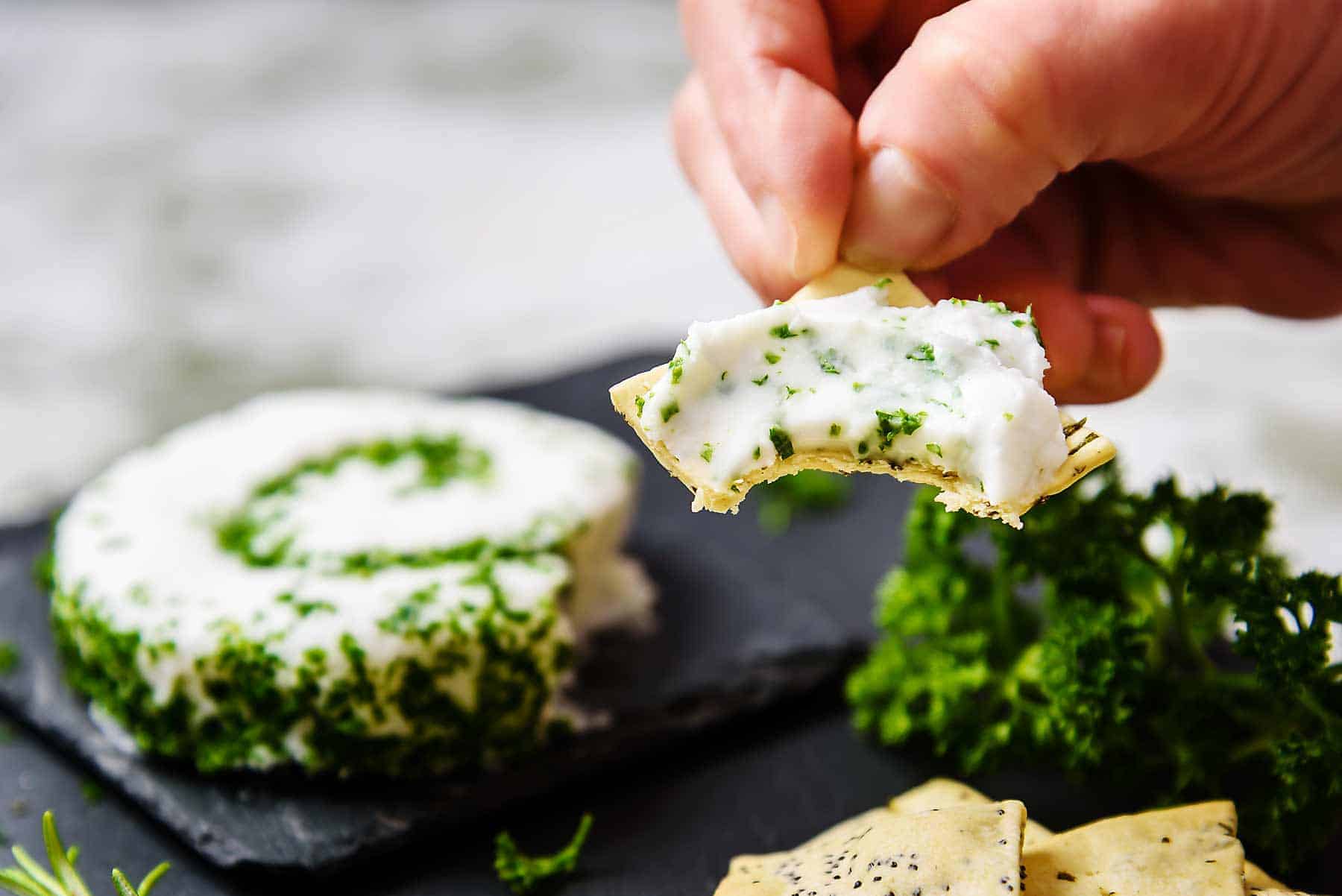 Vegan Le Roulé Cheese on a cracker with a bite taken
