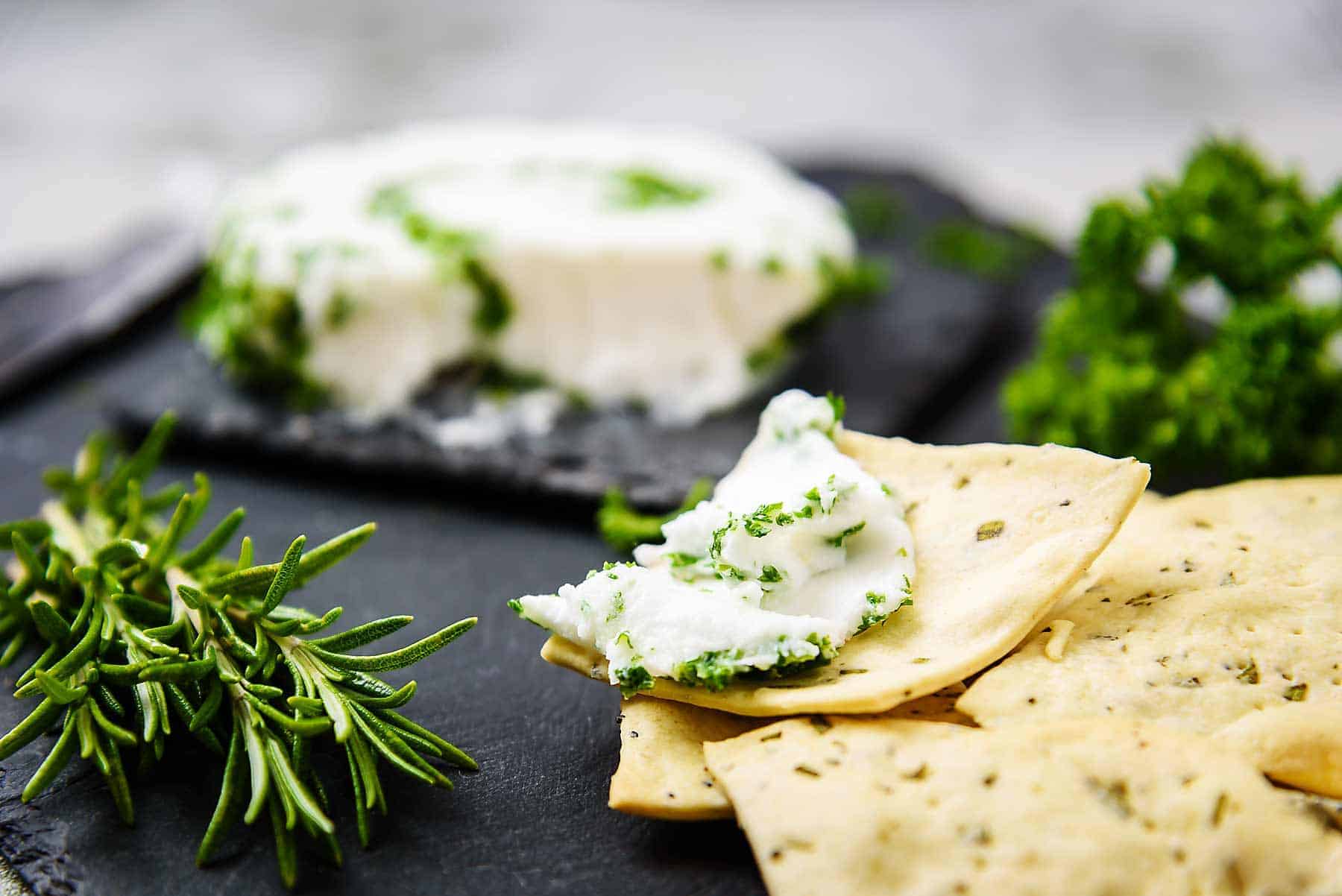 Vegan Rosemary & Poppyseed Crackers with cheese on