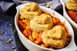Close up of cooked Bean & Vegetable Cumin Cobbler in serving dish