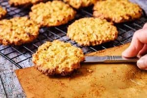 Placing cooked cookies on a wire rack to cool