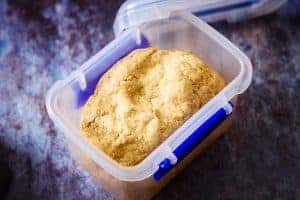 Vegan Cumin Cobbler Dough in a container for storage in the fridge