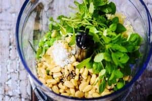 Ingredients for pesto in a food processor