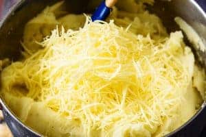 Adding cheese to the mashed potatoes
