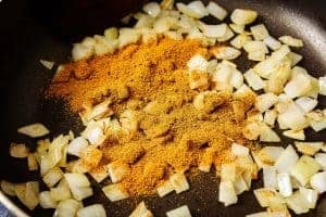 Adding the curry powder to the pan