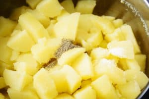 Adding salt and pepper to the cooked potatoes