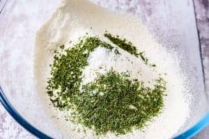 Adding the herbs to the flour