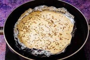Bread in foil on top of boiling water in a pan