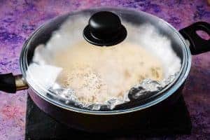 Bread steaming in a covered pan