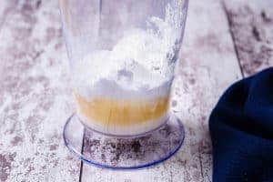 Ingredients for Vegan Sweetened Whipped Cream in a mixing container