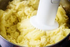 Mashing the potatoes with an electric masha