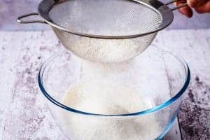 Sifting the flour into a bowl
