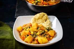 Vegan Potato & Vegetable Curry in a bowl with flatbread