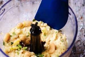 pushing the ingredients down the side of the processor with a spatula