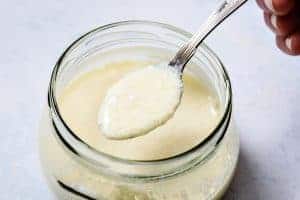 Spoon with lumpy milk on
