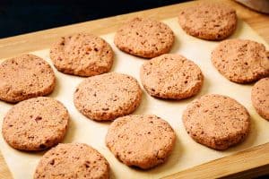 12 shaped patties on a board