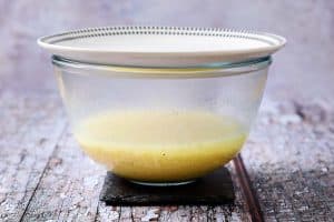 Bowl with couscous in stock water covered with a plate