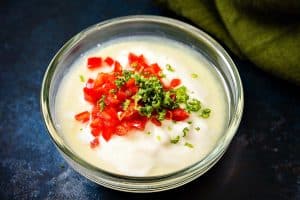 Chilli and lime added to yoghurt in a bowl