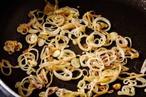 Cooked shallots in a frying pan