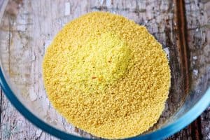 Dried couscous and stock powder in a bowl