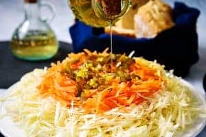Drizzling oil on Politiki (Greek Cabbage Salad)