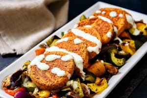 Lentil & Kidney Bean Patties with dressing drizzled over