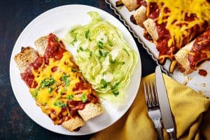 Overhead view of Close up of Vegan Vegetable & Bean Enchiladas served on a plate