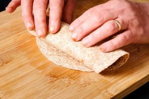 Rolling tortilla with the filling inside