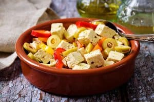 Vegan Tofu in Vinaigrette Dressing served with sliced peppers and olives