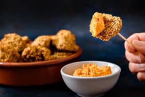 Baked Breaded Garlic Mushrooms on a cocktail stick with dip