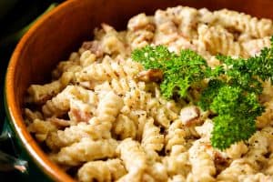 Close up of pasta & bacon in cashew sauce