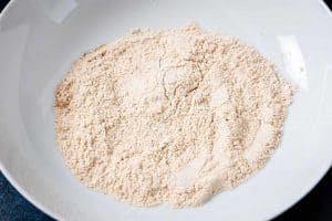 Flour and Cajun seasoning in a bowl