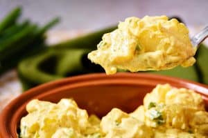 Vegan Potato Salad Indienne on a spoon